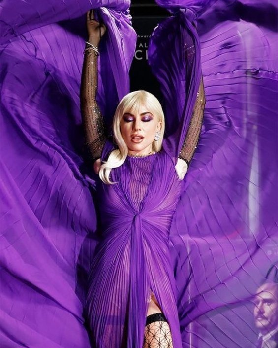 Lady Gaga strikes in a purple dress by Gucci at the premiere of House of Gucci
