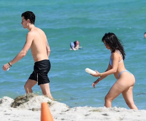 Camila Cabello in a blue bikini kisses Shawn Mendes on the beach in Miami