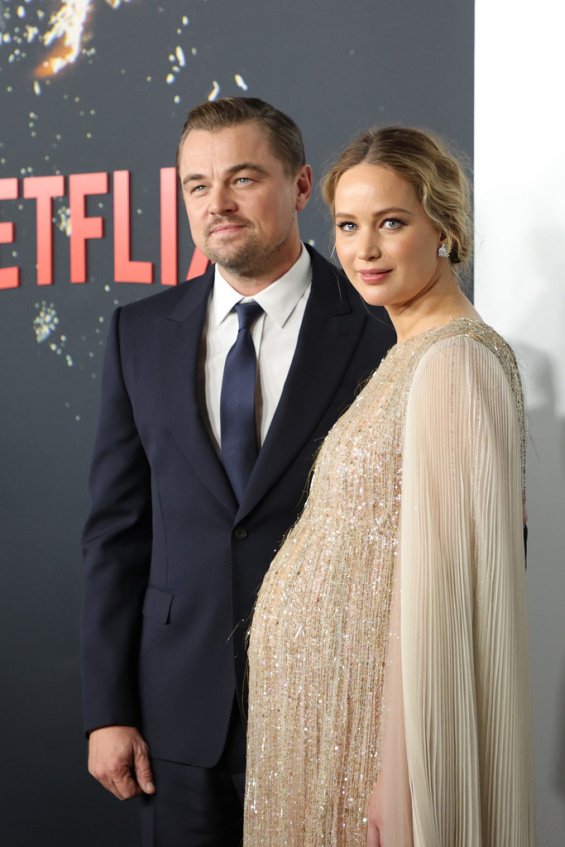 Jennifer Lawrence in a creation by Dior alongside Leonardo DiCaprio at the premiere