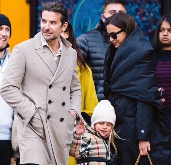 PHOTO: Irina Shayk and Bradley Cooper smiling arm in arm with daughter Lea in New York