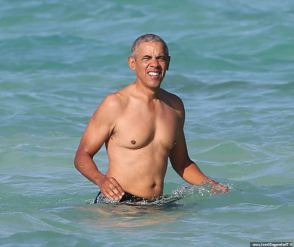 Barack Obama in a fit issue photographed in Hawaii with his daughters