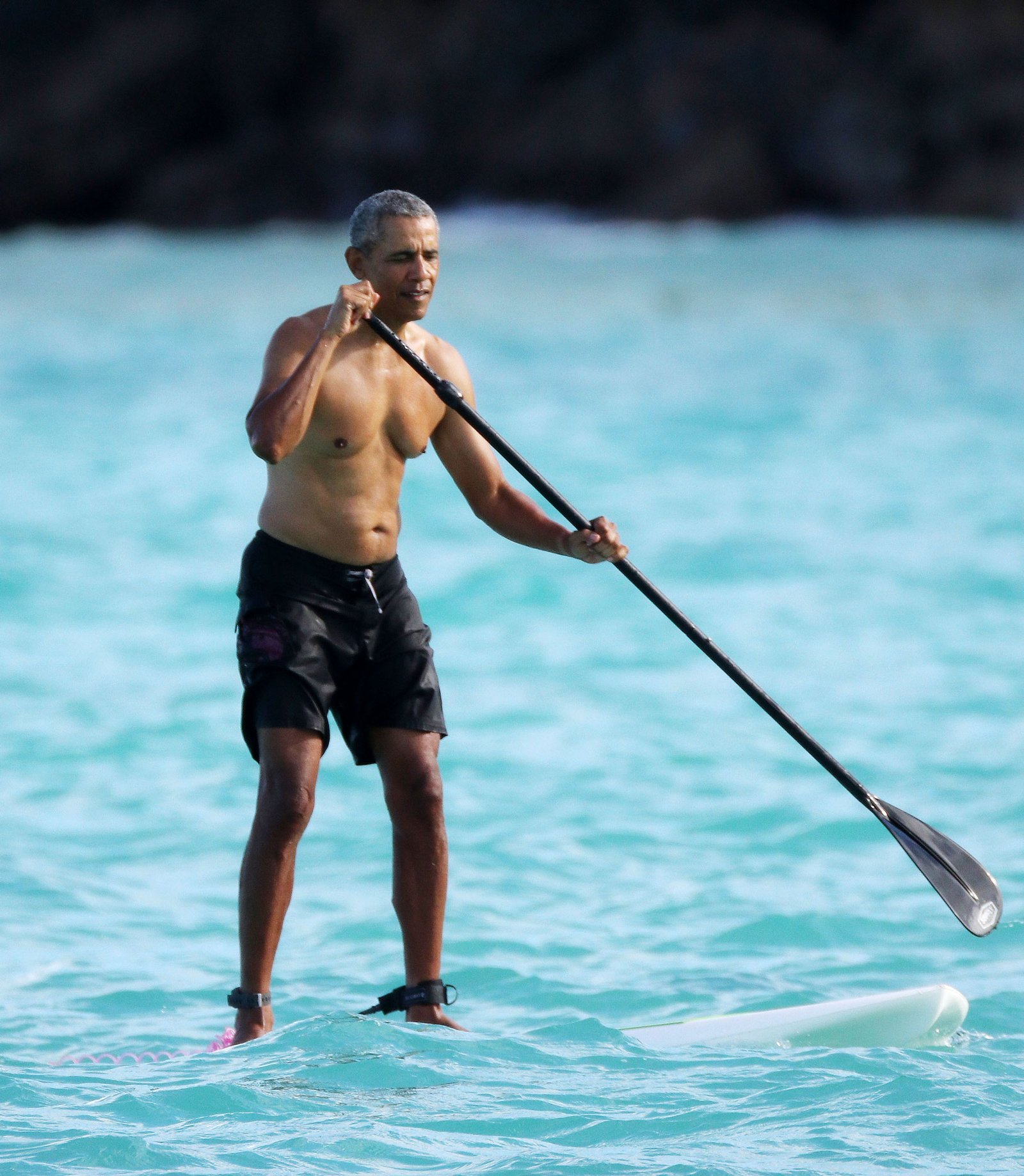 Barack Obama in a fit issue photographed in Hawaii with his daughters