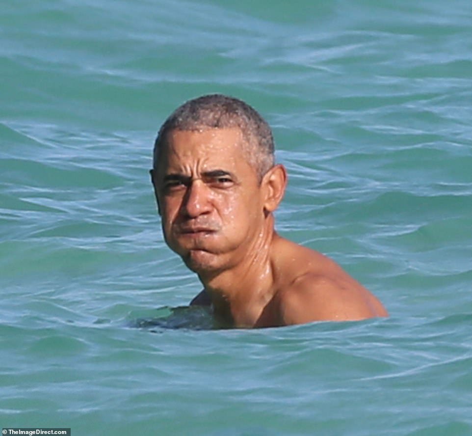 Barack Obama in a fit issue photographed in Hawaii with his daughters