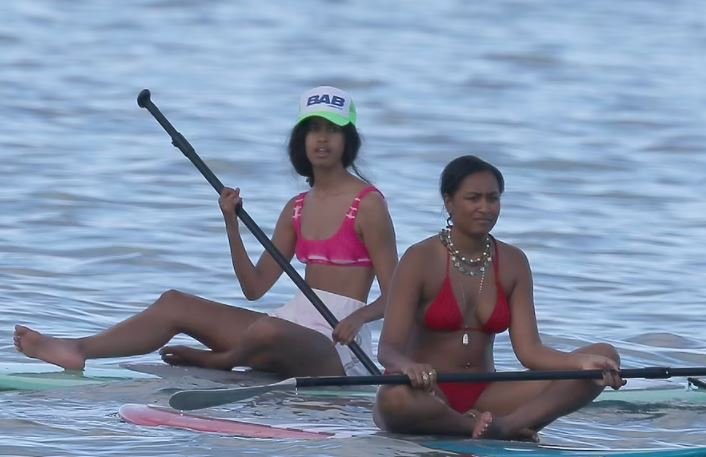 Barack Obama in a fit issue photographed in Hawaii with his daughters