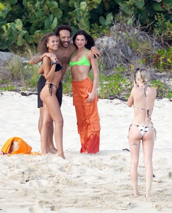 Dua Lipa relaxes on the beach in a neon bikini after breaking up with Anwar Hadid