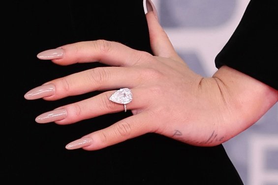 Adele at the Brit Awards with a glittering ring sparked rumors that she was engaged