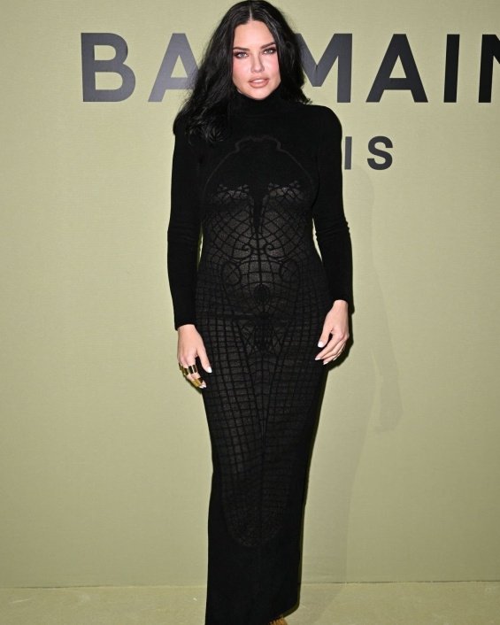 Adriana Lima highlighted her pregnant belly in a tight dress at a fashion show in Paris