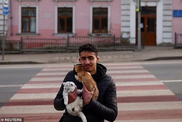 Emotional: Ukrainian refugees carry their pets across the border in their arms