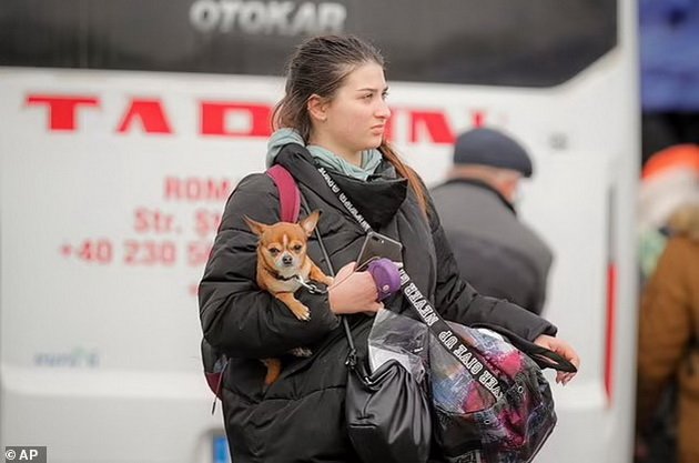 Emotional: Ukrainian refugees carry their pets across the border in their arms