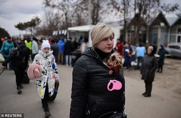 Emotional: Ukrainian refugees carry their pets across the border in their arms