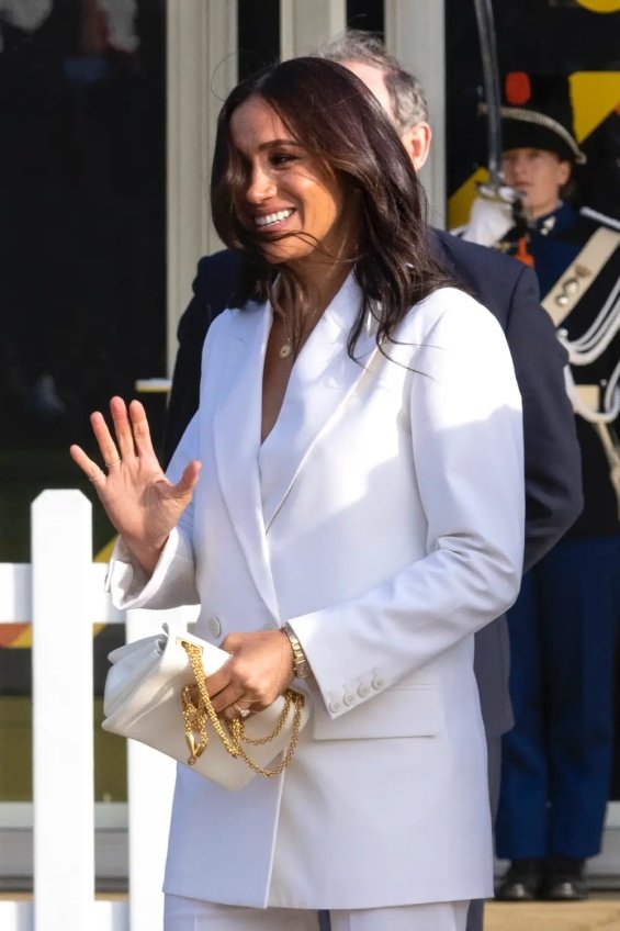 Meghan Markle in an elegant white suit next to Prince Harry in the Netherlands