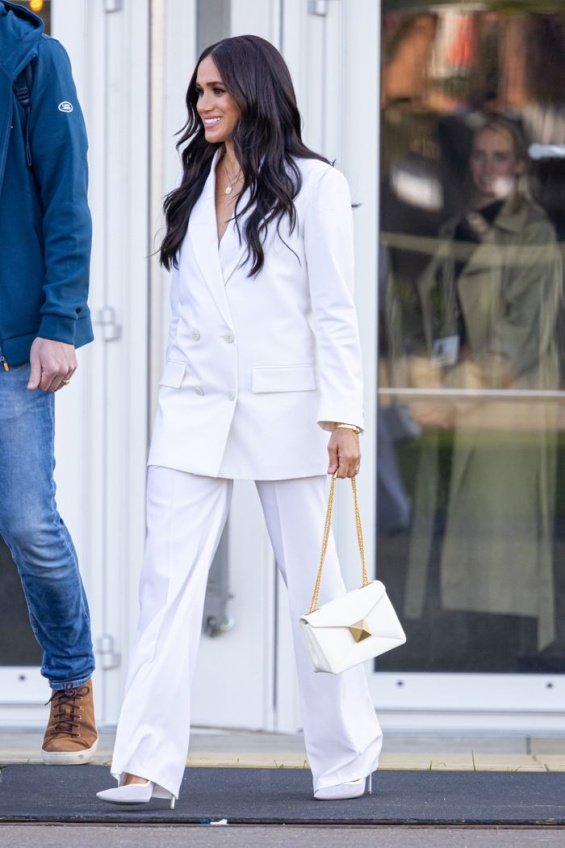 Meghan Markle in an elegant white suit next to Prince Harry in the Netherlands
