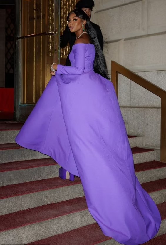 Naomi Campbell as a princess in a purple ball gown photographed at a gala