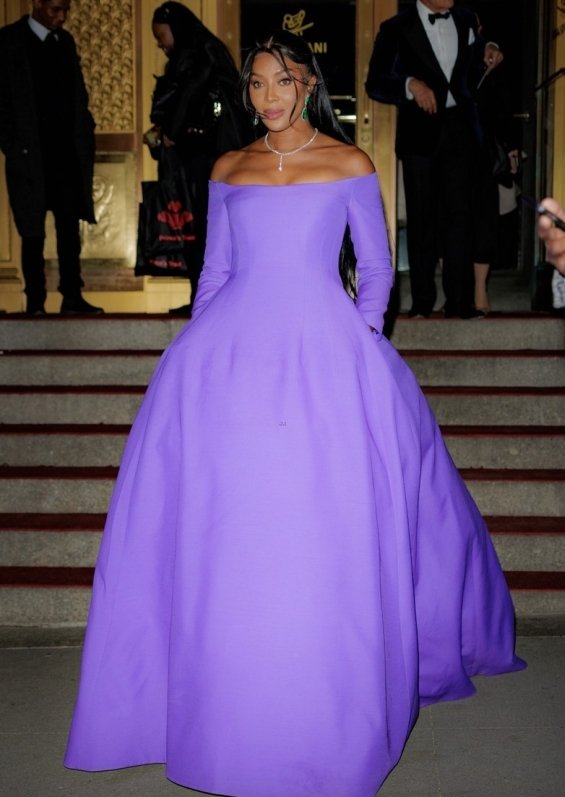 Naomi Campbell as a princess in a purple ball gown photographed at a gala