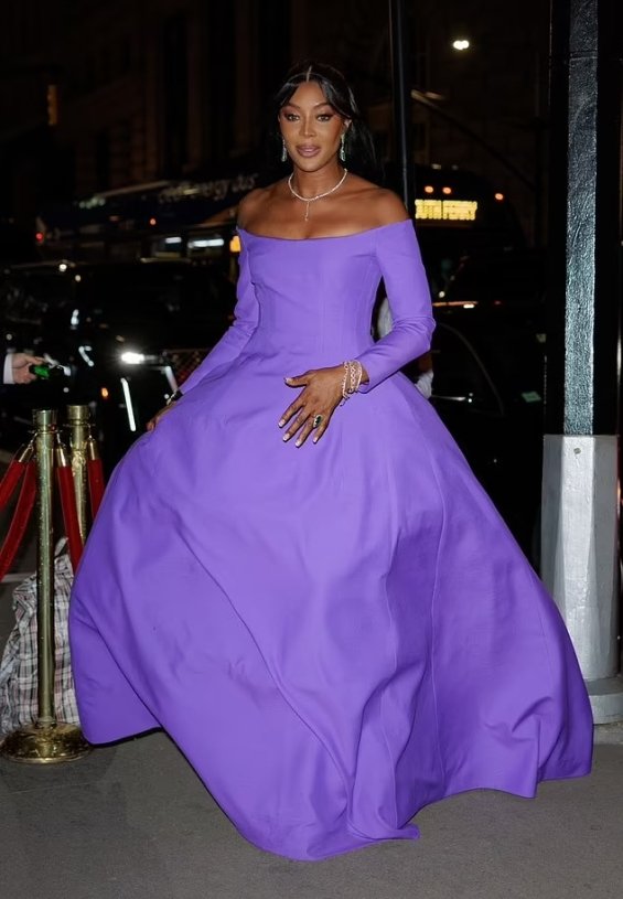 Naomi Campbell as a princess in a purple ball gown photographed at a gala