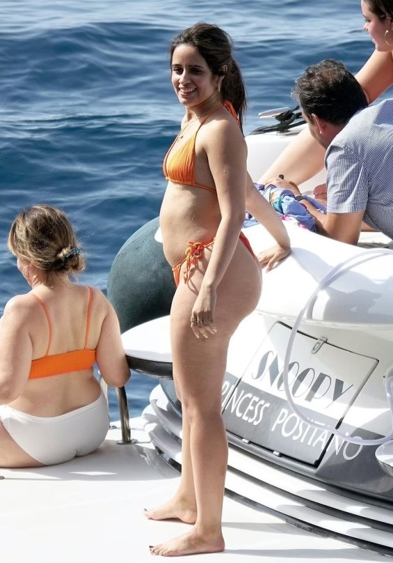 Camila Cabello in an orange bikini enjoys a yacht with friends in Positano