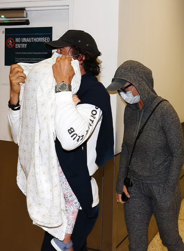 PHOTO: Katy Perry and Orlando Bloom hide from paparazzi at the airport