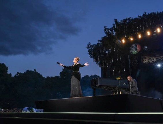 Adele in a black creation that accentuates her figure at a concert in London