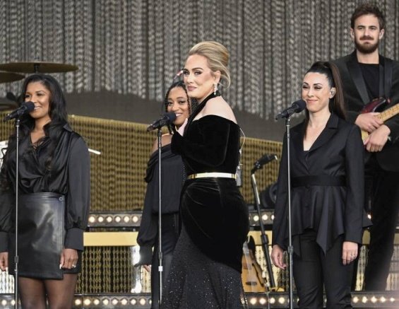 Adele in a black creation that accentuates her figure at a concert in London