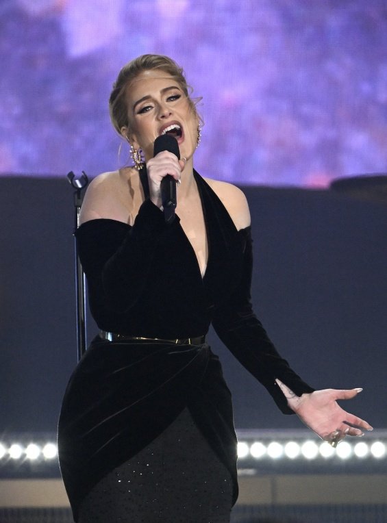 Adele in a black creation that accentuates her figure at a concert in London