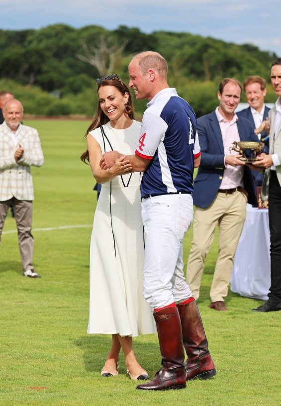 Duchess Catherine in a summery white dress cheers on Prince William at a polo match