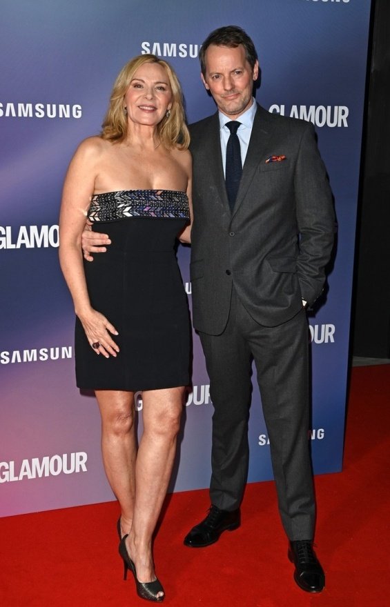 Kim Cattrall in a little black dress at an event with her partner