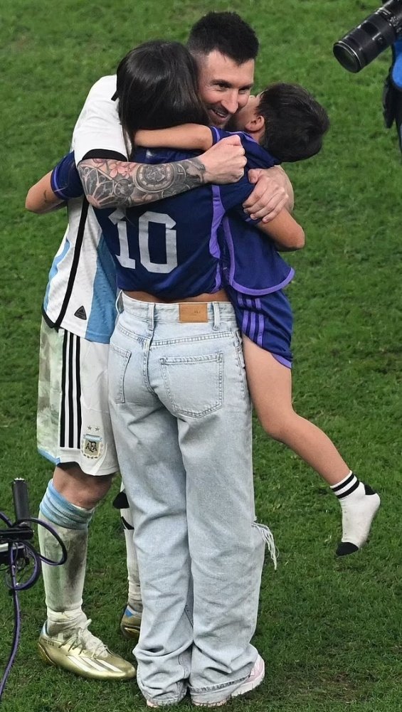 Lionel Messi in the arms of his wife and three sons celebrated for winning the World Cup