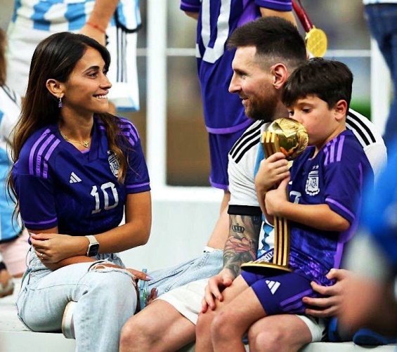 Lionel Messi in the arms of his wife and three sons celebrated for winning the World Cup