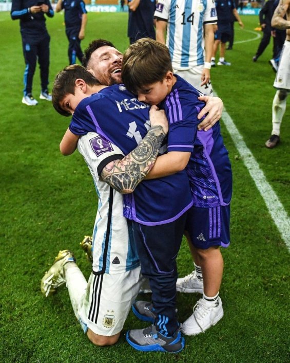 Lionel Messi in the arms of his wife and three sons celebrated for winning the World Cup