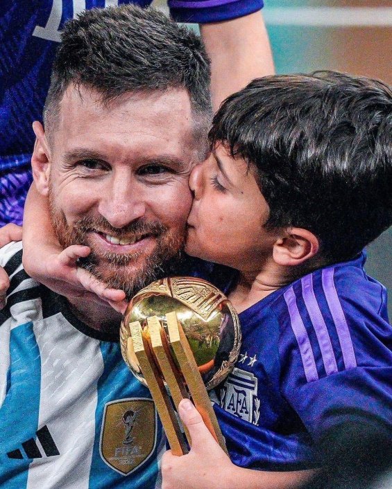 Lionel Messi in the arms of his wife and three sons celebrated for winning the World Cup