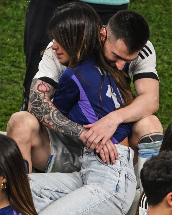 Lionel Messi in the arms of his wife and three sons celebrated for winning the World Cup