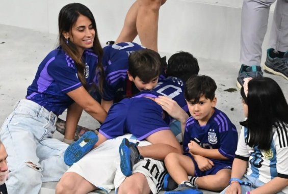 Lionel Messi in the arms of his wife and three sons celebrated for winning the World Cup