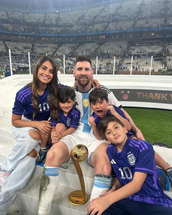 Lionel Messi in the arms of his wife and three sons celebrated for winning the World Cup