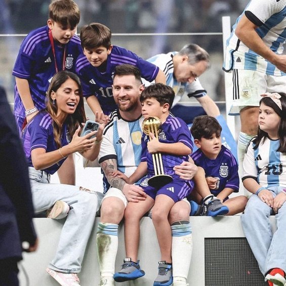 Lionel Messi in the arms of his wife and three sons celebrated for winning the World Cup