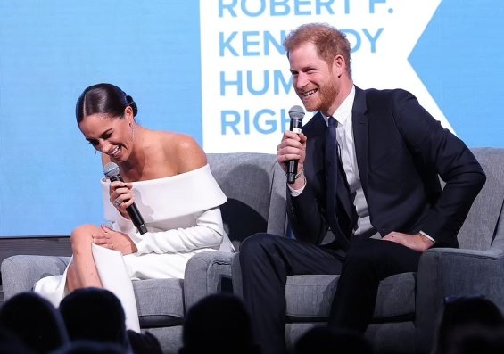 Meghan Markle next to Prince Harry at an event where they received an award