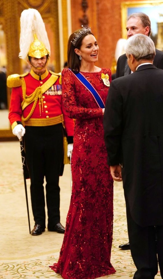 Princess Catherine dressed up in a red creation and tiara at a reception at Buckingham Palace