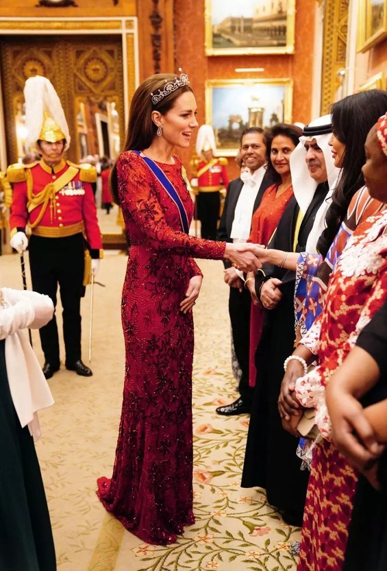 Princess Catherine dressed up in a red creation and tiara at a reception at Buckingham Palace