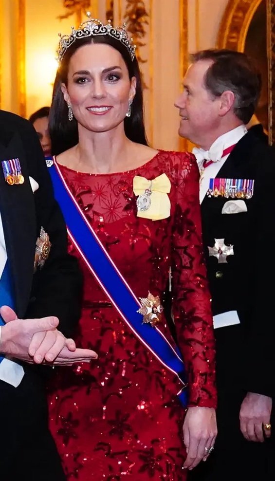 Princess Catherine dressed up in a red creation and tiara at a reception at Buckingham Palace