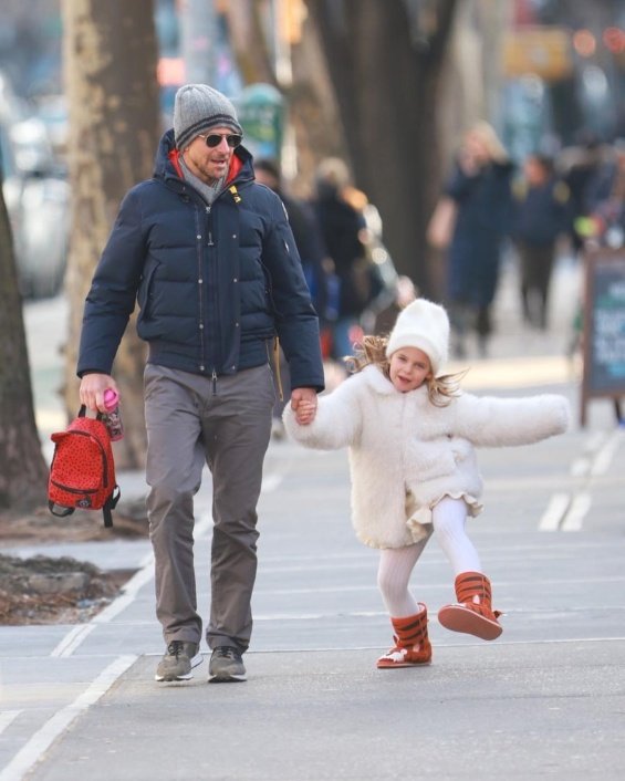 Bradley Cooper holding hands with his daughter photographed on a walk