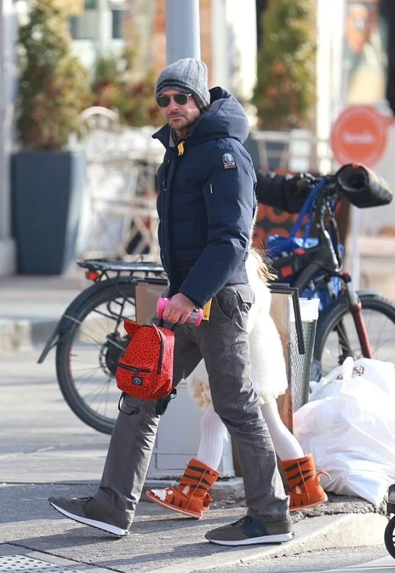 Bradley Cooper holding hands with his daughter photographed on a walk