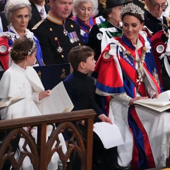 Princess Charlotte with a flower wreath as Princess Catherine holding hands with brother Louis at the coronation