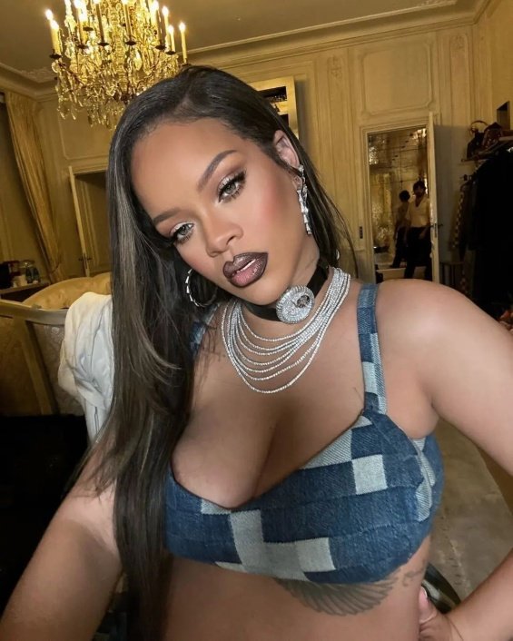 Rihanna bares her pregnant belly in denim styling at the Louis Vuitton men's show