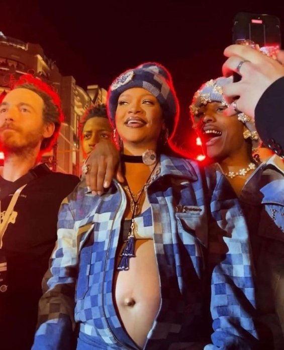 Rihanna bares her pregnant belly in denim styling at the Louis Vuitton men's show