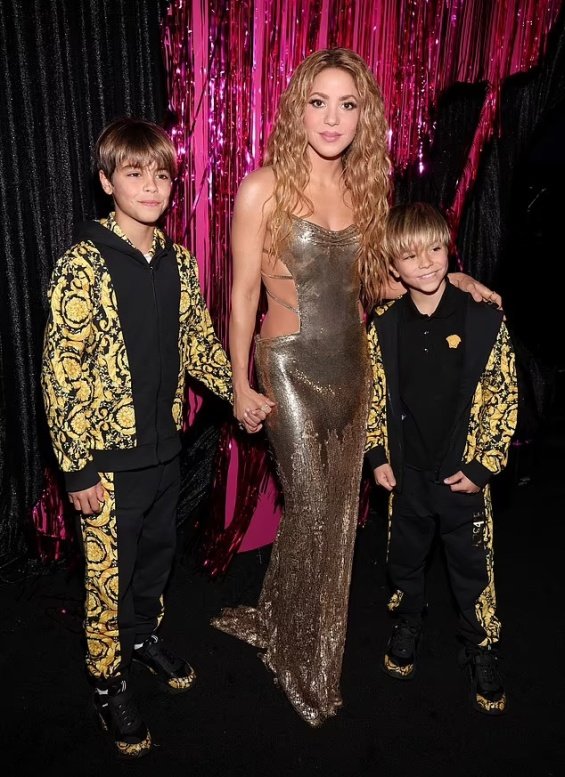 Shakira In A Gold Versace Creation With Sons Sasha And Milan At The MTV VMAs